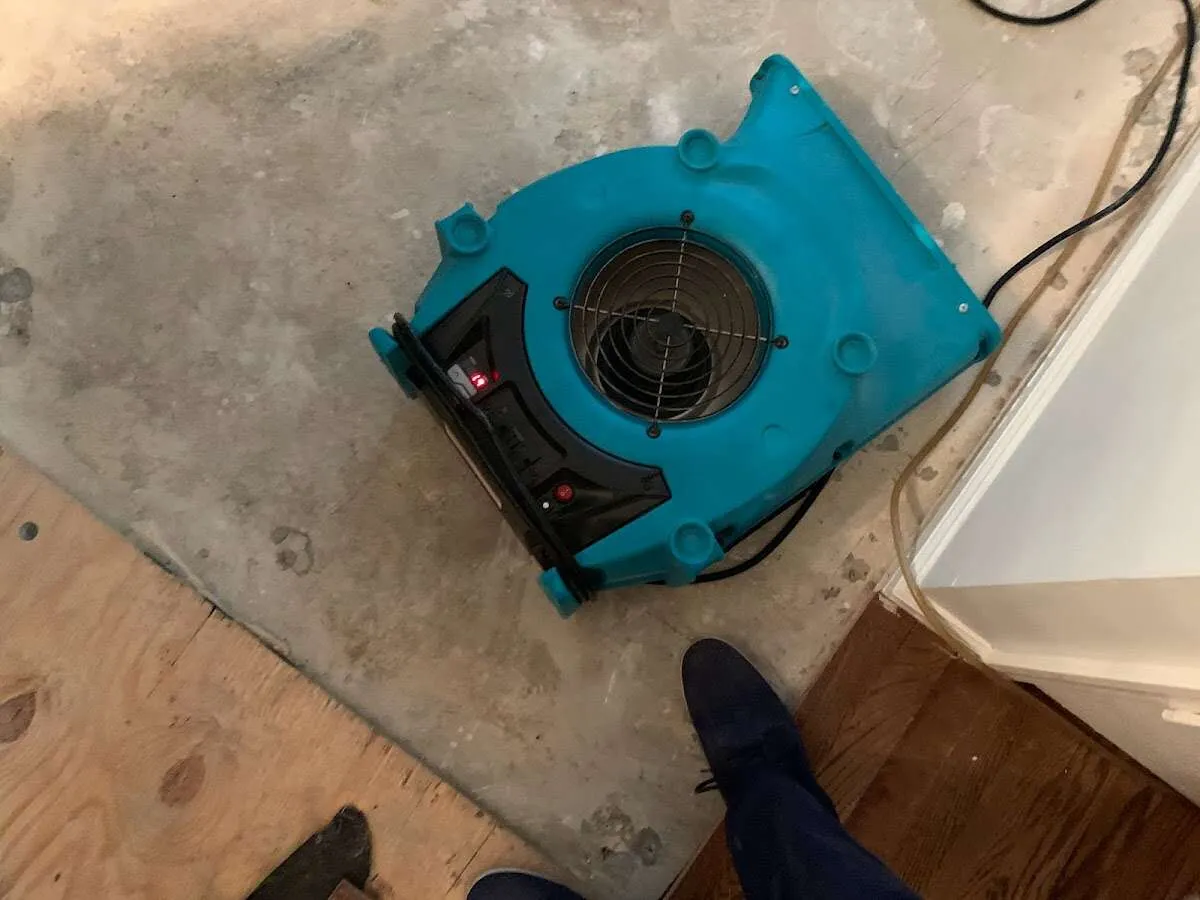 Air mover drying subfloor during Commercial Water Damage Restoration in Waconia